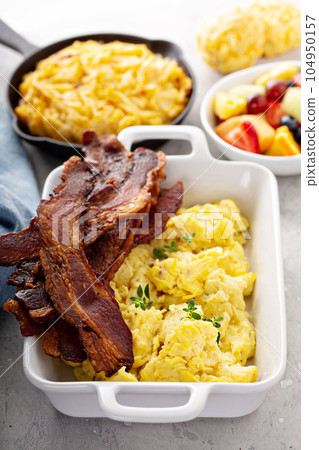 Full breakfast with scrambled eggs, bacon and potatoes Full breakfast with scrambled eggs, bacon and potatoes 104950157
