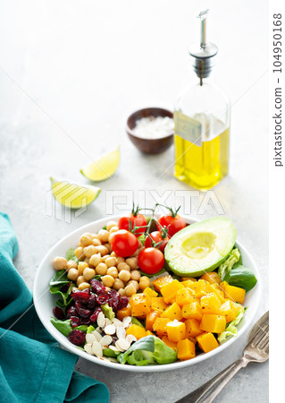 Vegan lunch bowl with chickpeas and roasted squash 104950168