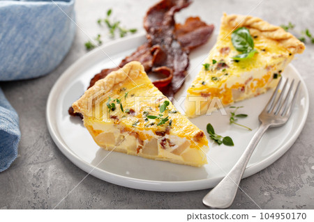 Breakfast plate with bacon and potato quiche 104950170