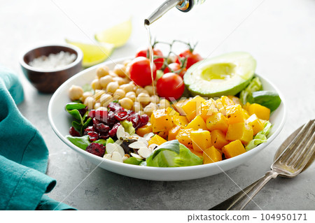 Vegan lunch bowl with chickpeas and roasted squash 104950171