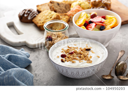Breakfast table with granola, yogurt and fruit Breakfast table with granola, yogurt and fruit 104950203
