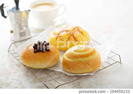 Variety of breakfast buns with coffee 104950233