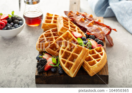 Breakfast platter with waffles, berries and bacon 104950365
