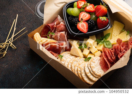 Cheese and meat assortment in a to go box 104950532