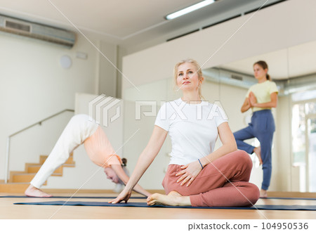 Woman practicing yoga in studio 104950536