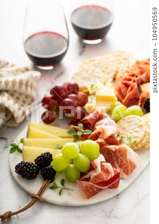 Charcuterie board with cheese and meat Charcuterie board with cheese and meat 104950569