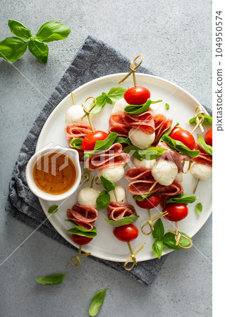 Italian style appetizer, caprese on a stick Italian style appetizer, caprese on a stick 104950574