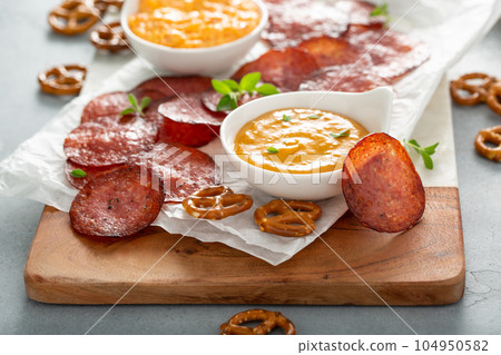 Salami chips baked in the oven with cheese sauces Salami chips baked in the oven with cheese sauces 104950582