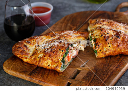 Traditional calzone cut in half Traditional calzone cut in half 104950939