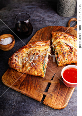 Traditional calzone cut in half Traditional calzone cut in half 104950940