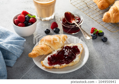 Fresh summer breakfast with croissants and berry jam Fresh summer breakfast with croissants and berry jam 104950941