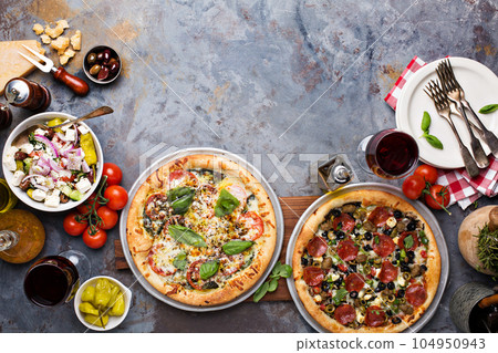 Pizza Margarita and Pepperoni with garnishes 104950943