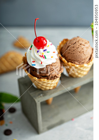 Chocolate ice cream in waffle cones 104950953