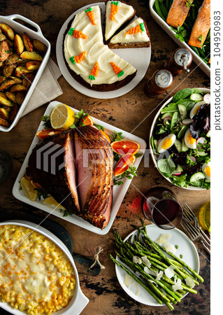 Easter dinner table with ham, asparagus and cake 104950983