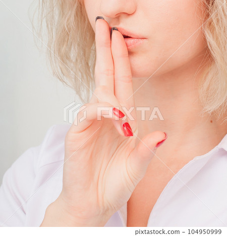 keeps fingers on lips, demonstrates silence sign, has a secret. 104950999