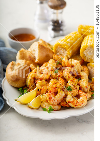 Fried shrimp and corn on the cob Fried shrimp and corn on the cob 104951139