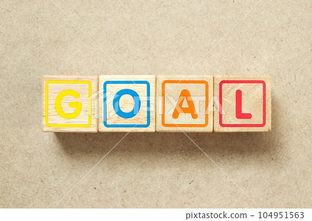 Wooden alphabet letter block in word goal on wood background Wooden alphabet letter block in word goal on wood background 104951563