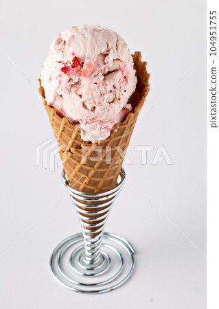 Strawberry ice cream in waffle cone Strawberry ice cream in waffle cone 104951755