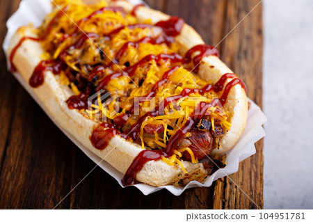 Grilled beef hot dog with bacon and cheese 104951781