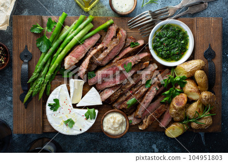 Sliced steak with asparagus and potatoes Sliced steak with asparagus and potatoes 104951803