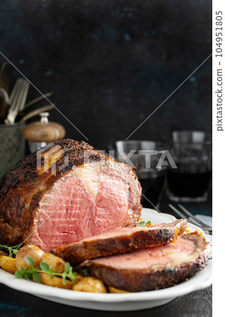 Roast beef with potatoes for a holiday dinner Roast beef with potatoes for a holiday dinner 104951805
