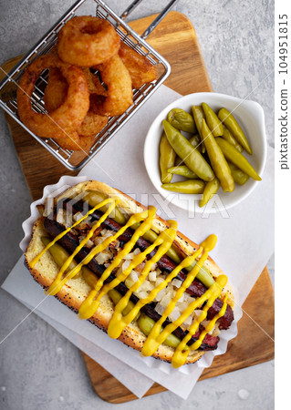 Hot dog on a poppy seed bun with onion 104951815