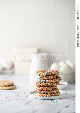 Sugar cookies with sprinkles and a bottle of milk 104951929