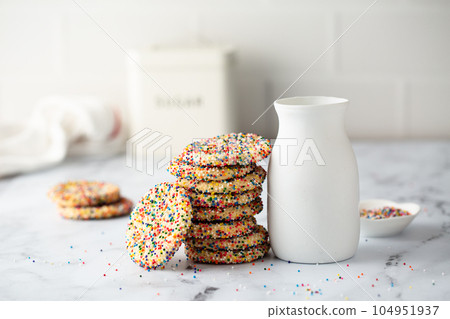 Sugar cookies with sprinkles and a bottle of milk Sugar cookies with sprinkles and a bottle of milk 104951937