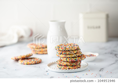 Sugar cookies with sprinkles and a bottle of milk Sugar cookies with sprinkles and a bottle of milk 104951946