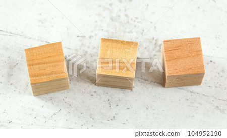 Three blank wooden playing cubes on white board 104952190