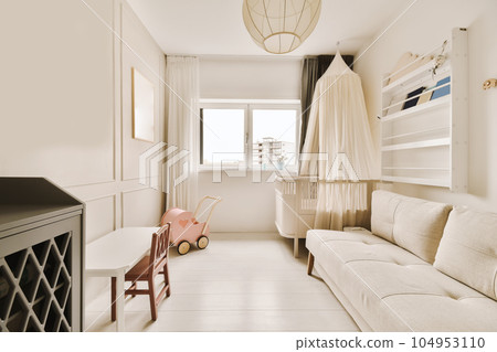 a living room with a white couch and wooden table in the center of the room is a large window that looks out onto the a living room with a white couch and wooden table in the center of the room is a large window that looks out onto the 104953110