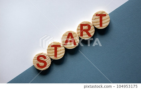 Wood circles with word 'start' on paper blue and white background, copy space. Business concept success process. 104953175
