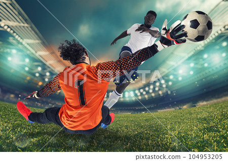 Goalkeeper catches the ball in the stadium during a football game 104953205
