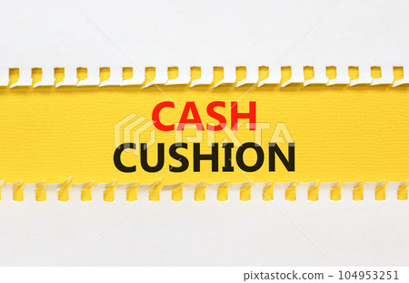 Cash cushion symbol. Concept words Cash cushion on beautiful yellow paper. Beautiful white table white background. Business and Cash cushion concept. Copy space. Cash cushion symbol. Concept words Cash cushion on beautiful yellow paper. Beautiful white table white background. Business and Cash cushion concept. Copy space. 104953251