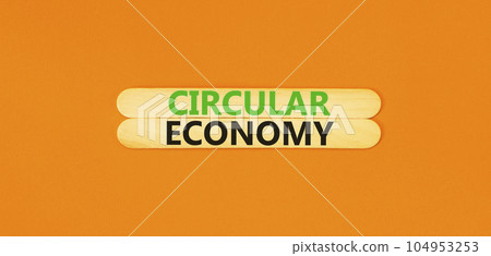 Circular economy symbol. Concept words Circular economy on beautiful wooden stick. Beautiful orange table orange background. Business circular economy concept. Copy space. 104953253