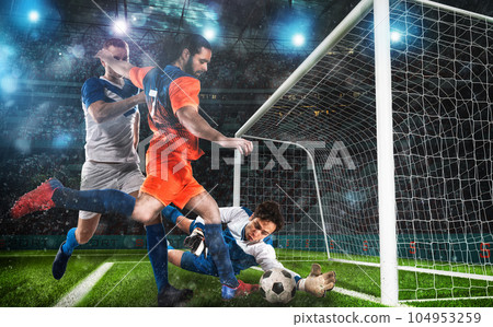 Football action with the attacker contrasted by the defenders trying to do goal at the goalkeeper 104953259