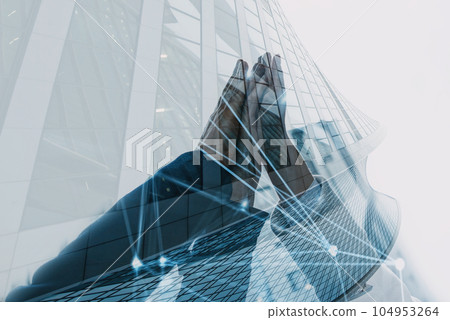 Handshaking between businessmen. Double exposure with modern office 104953264