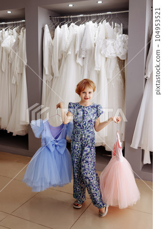 Little kid shopper or customer buying clothes. 104953521