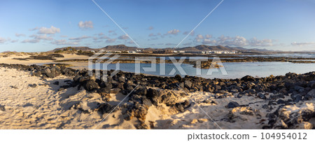 Panoramic view of El Cotillo city in Fuerteventura, Canary Islands, Spain. Scenic colorful traditional villages of Fuerteventura, El Cotillo in northen part of island. Canary islands of Spain. Panoramic view of El Cotillo city in Fuerteventura, Canary Islands, Spain. Scenic colorful traditional villages of Fuerteventura, El Cotillo in northen part of island. Canary islands of Spain. 104954012