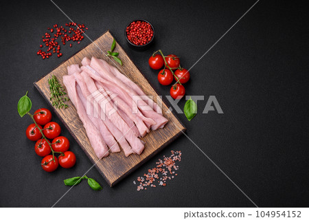 Raw chicken or turkey fillet cut into strips with spices and herbs Raw chicken or turkey fillet cut into strips with spices and herbs 104954152