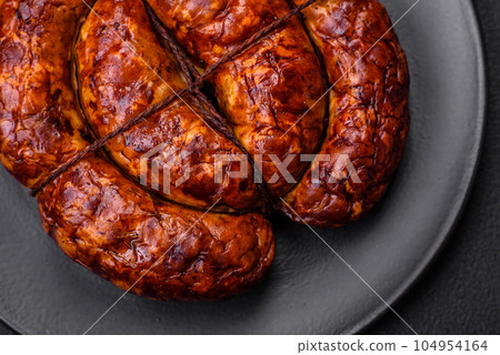 Delicious grilled sausage in the form of a ring with salt, spices and herbs Delicious grilled sausage in the form of a ring with salt, spices and herbs 104954164