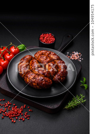 Delicious grilled sausage in the form of a ring with salt, spices and herbs Delicious grilled sausage in the form of a ring with salt, spices and herbs 104954175