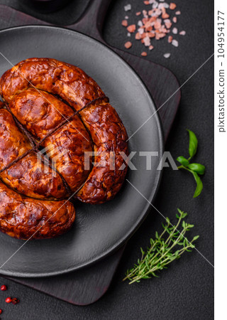 Delicious grilled sausage in the form of a ring with salt, spices and herbs Delicious grilled sausage in the form of a ring with salt, spices and herbs 104954177