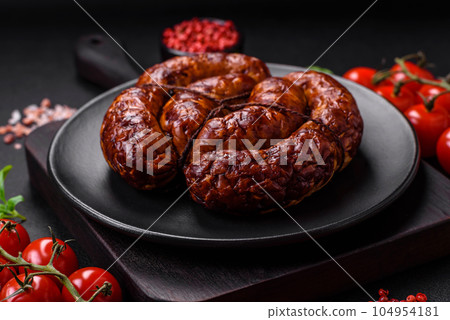 Delicious grilled sausage in the form of a ring with salt, spices and herbs Delicious grilled sausage in the form of a ring with salt, spices and herbs 104954181