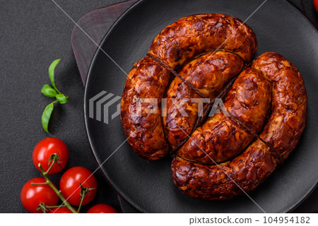 Delicious grilled sausage in the form of a ring with salt, spices and herbs Delicious grilled sausage in the form of a ring with salt, spices and herbs 104954182