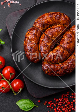 Delicious grilled sausage in the form of a ring with salt, spices and herbs 104954183
