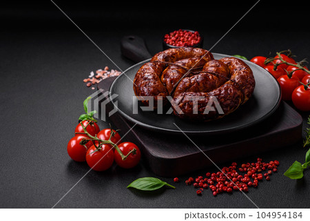 Delicious grilled sausage in the form of a ring with salt, spices and herbs Delicious grilled sausage in the form of a ring with salt, spices and herbs 104954184