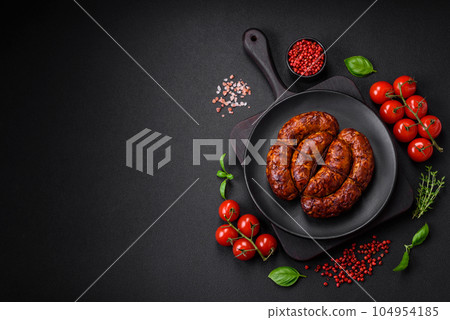 Delicious grilled sausage in the form of a ring with salt, spices and herbs Delicious grilled sausage in the form of a ring with salt, spices and herbs 104954185