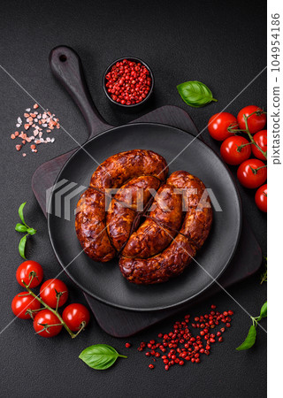 Delicious grilled sausage in the form of a ring with salt, spices and herbs Delicious grilled sausage in the form of a ring with salt, spices and herbs 104954186