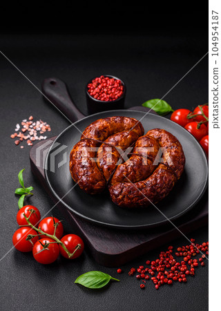 Delicious grilled sausage in the form of a ring with salt, spices and herbs Delicious grilled sausage in the form of a ring with salt, spices and herbs 104954187